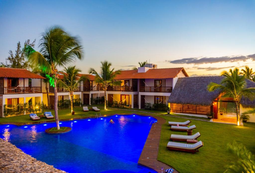 a villa with a swimming pool and a resort at Villa Zen Hotel in Camocim