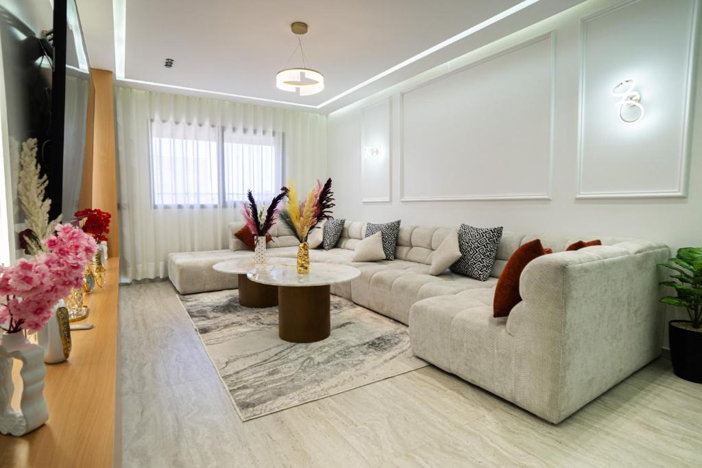 a living room with a couch and a table at flora bay luxe in Agadir