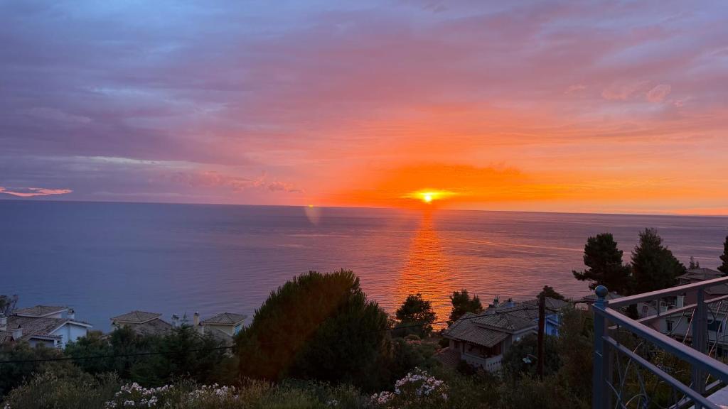 a sunset over the ocean with the sun in the sky at Aurora Maris Maisonette in Possidi
