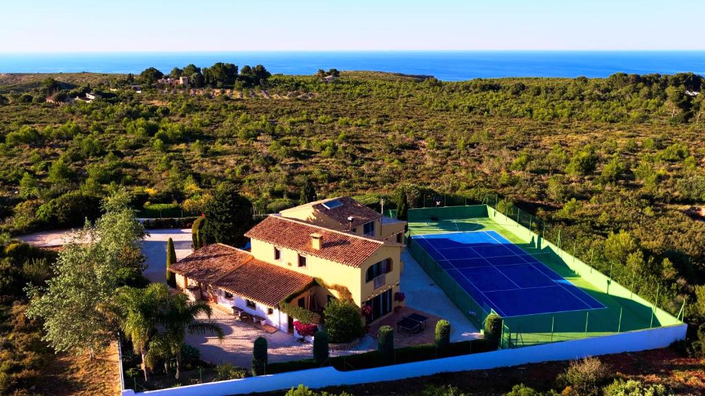 an aerial view of a house with a tennis court at Secrets Rural House in Jávea