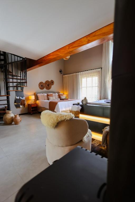 a large living room with a bed and a couch at Fruto Vermelho Pousada in Pedra Menina