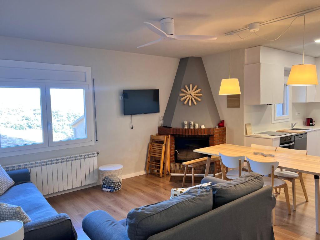 a living room with a couch and a table at Apartaments La Pertusa 1 in Corçà