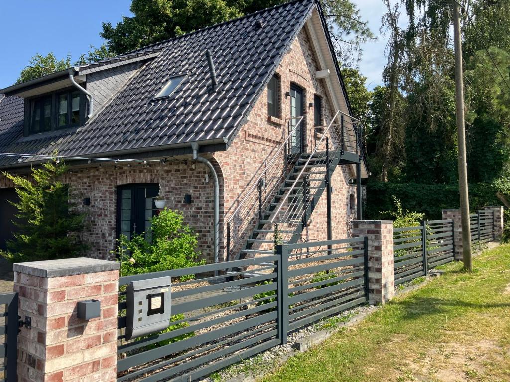 a brick house with a staircase on the side of it at Ferienwohnung am Woezer See in Woez