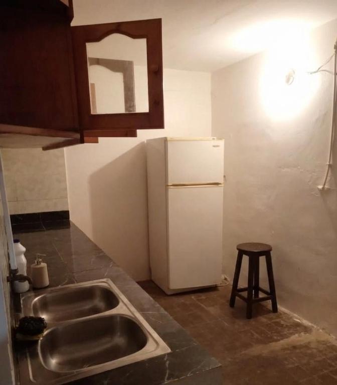 a kitchen with a sink and a white refrigerator at colomina in Sidi Ifni