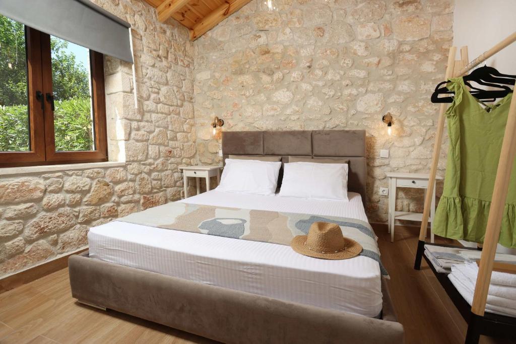 a bedroom with a bed with a hat on it at Living in in Afitos