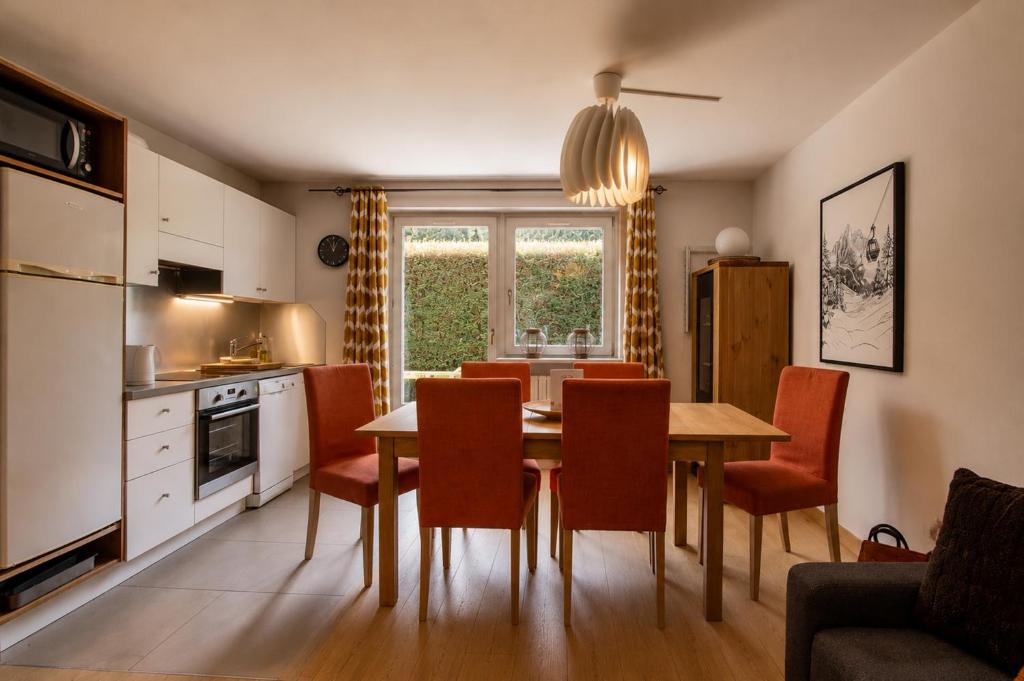a kitchen and dining room with a table and chairs at Apartment Picasso in Chamonix