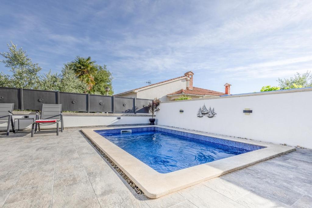 a swimming pool in the backyard of a house at Little Paradise in Nova Vas