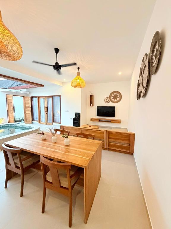 a kitchen and dining room with a wooden table at Yamore Villa in Gili Islands