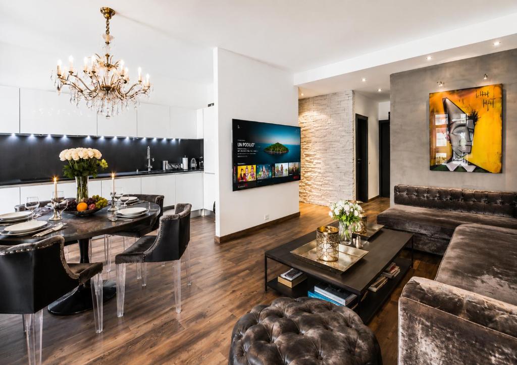 a living room with a dining table and a couch at LUXUEUX APPARTEMENT AU COEUR DE GENEVE ,a deux pas du LAC in Geneva