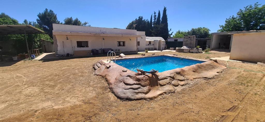 a swimming pool in the yard of a house at Casa La Ermita in Montmesa