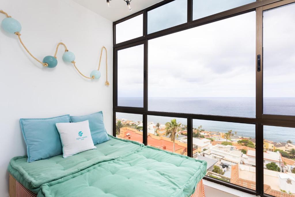 a room with a bed and a large window at Don Rafael # Ocean views # Natural pools in Bajamar