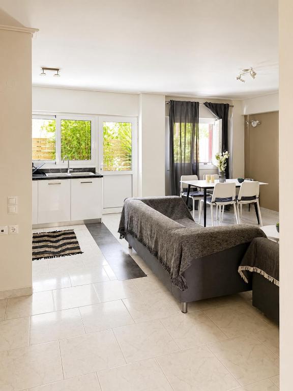 a living room with a large bed and a kitchen at polyxeni house in Lygia