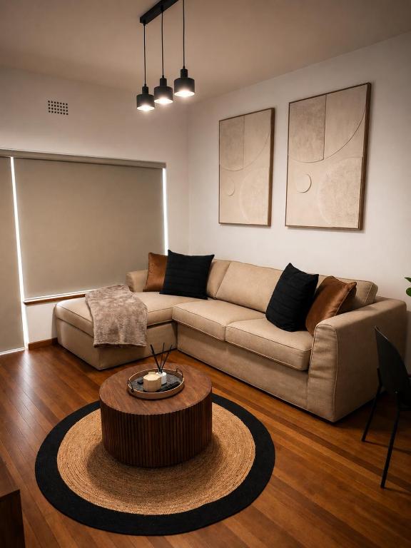 a living room with a couch and a coffee table at The Oak in Strand