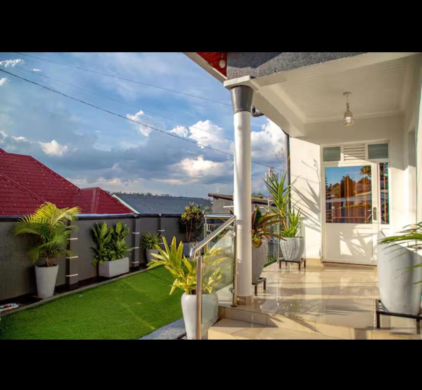 a balcony of a house with potted plants on it at PENTHOUSE MPINGA RIMWEe in Kigali