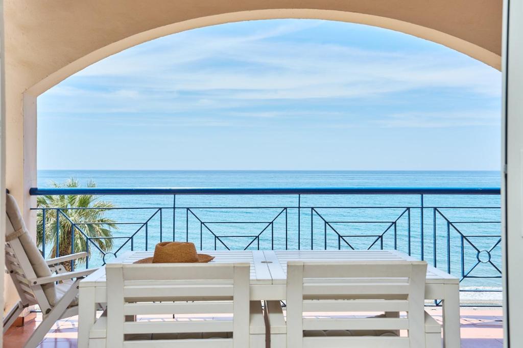 a table with chairs and a view of the ocean at Blue View in Torrox Costa