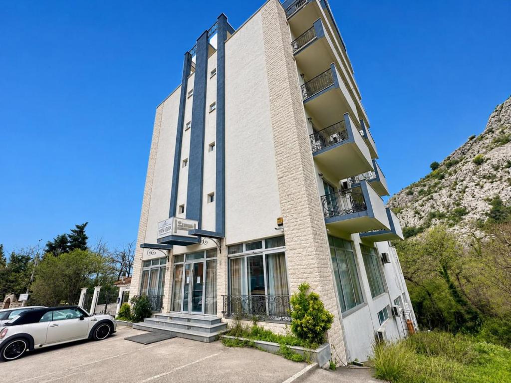 a building with a car parked in front of it at WEST GATE free parking & wi-fi in Sutomore