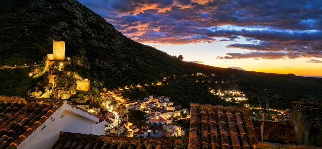 a view of a city from a mountain at sunset at La Pizpireta in Cazorla