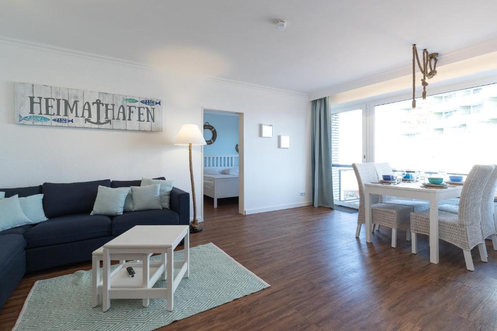 a living room with a couch and a table at Düne, App 7 in Duhnen