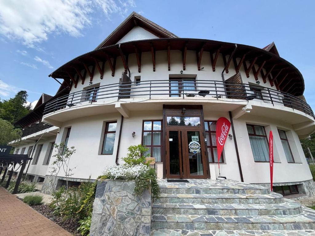 a large white house with a round roof at Rotonde View in Predeal