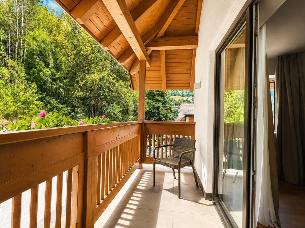 a balcony of a house with a chair at Riolina Suite in Mühlbach