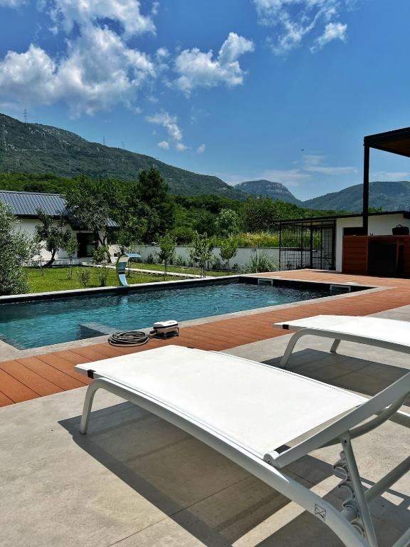 a white bench sitting next to a swimming pool at Villa Harmonia in Glavati