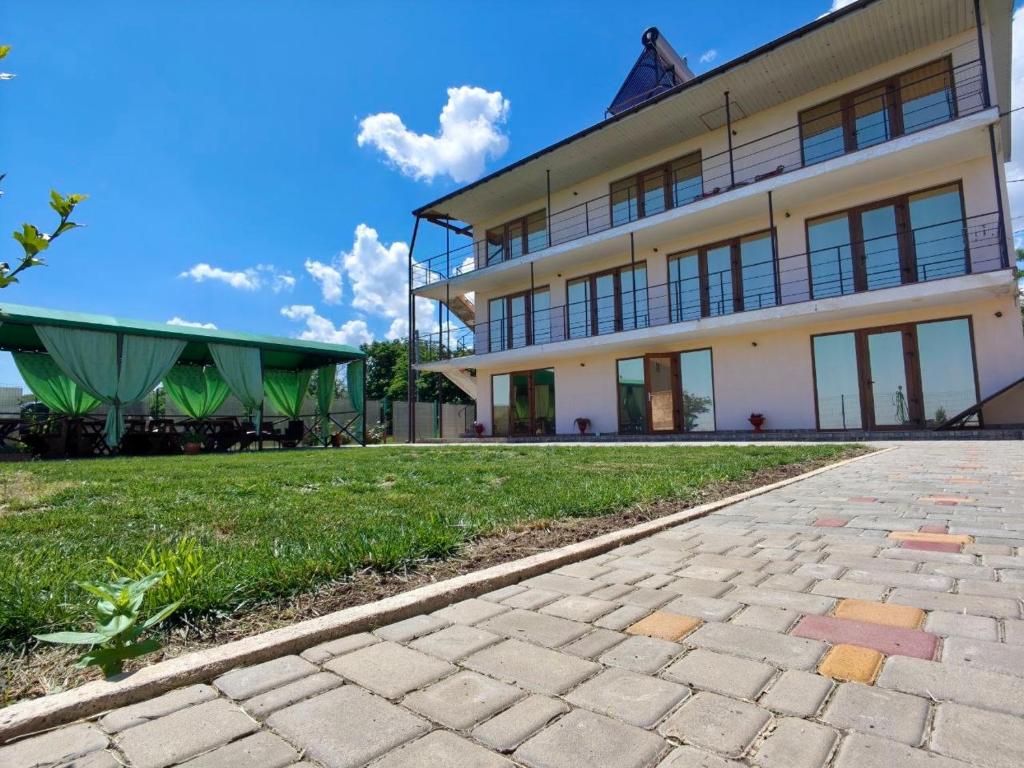 a large white building with a green roof at Гостинний дім "Алмаз" in Kurortne