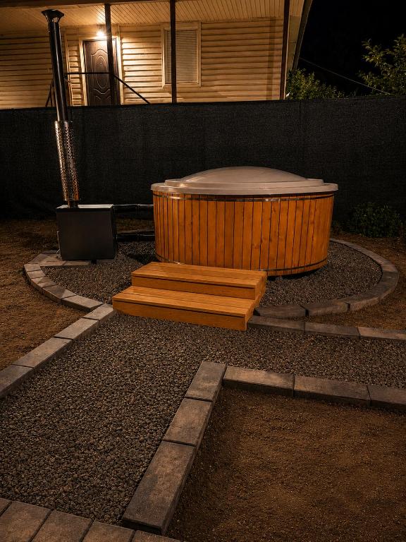 a wooden tub sitting in the middle of a yard at Graphite House in Kyiv