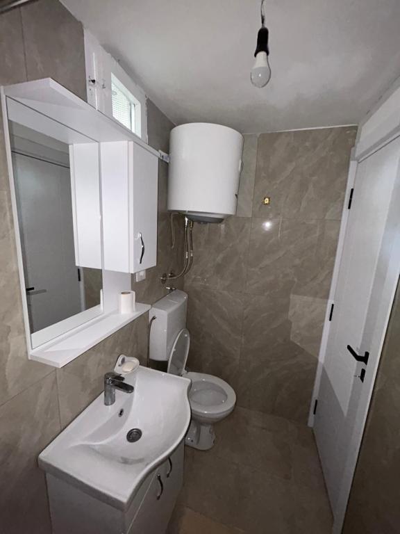 a bathroom with a white sink and a toilet at Cottage near Ostrog in Gornja Povija