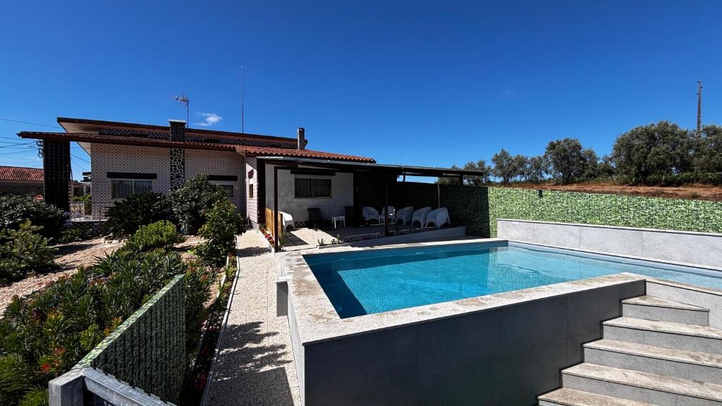 a swimming pool in the backyard of a house at Casa dos Neto Santiago in Anadia
