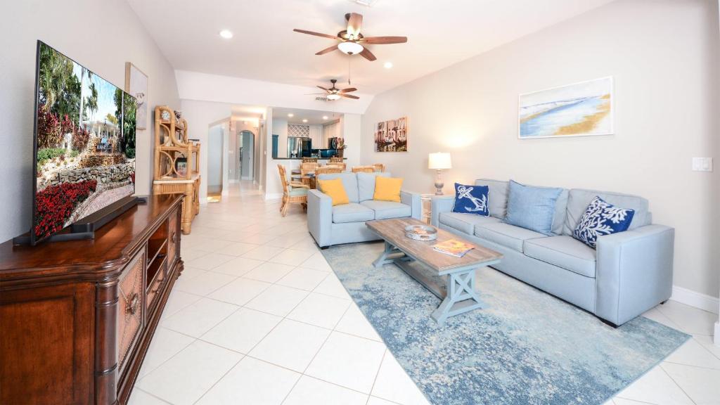 a living room with a couch and a tv at 207 Mariners Club in Key Largo