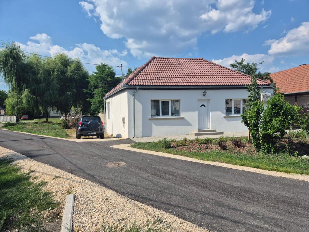 a white house on the side of a road at La Casa Vendégház in Bogács
