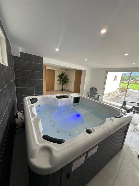 a large bath tub in a room with at Nouveauté Gite la virée verte in Vagney