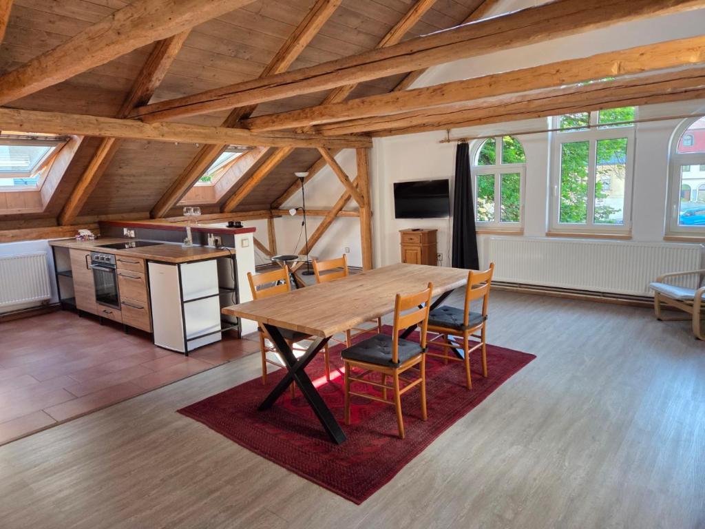 a kitchen and dining room with a wooden table and chairs at Apartmán U lípy in Semily