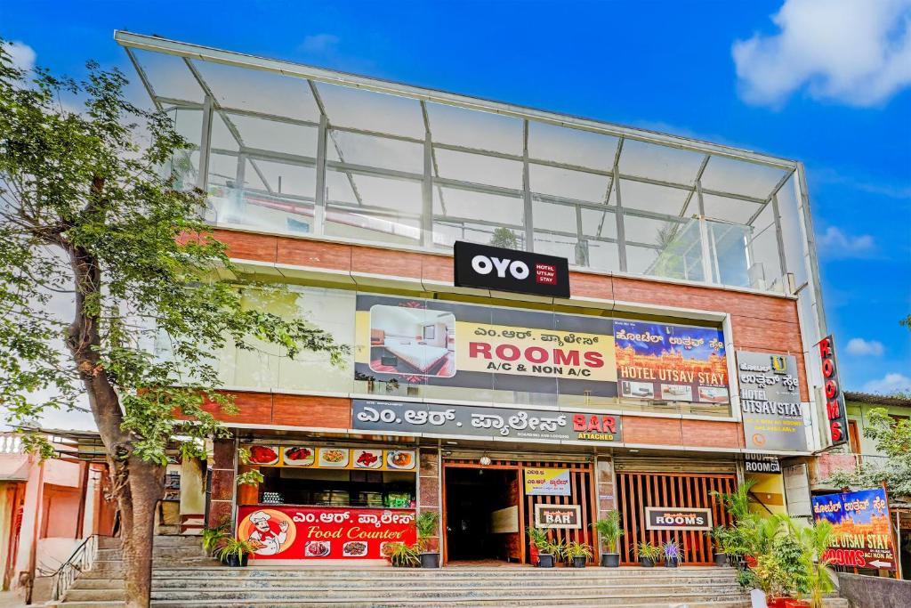 a store front of a building with a roof at Super HOTEL O UTSAV STAY in Jālahalli