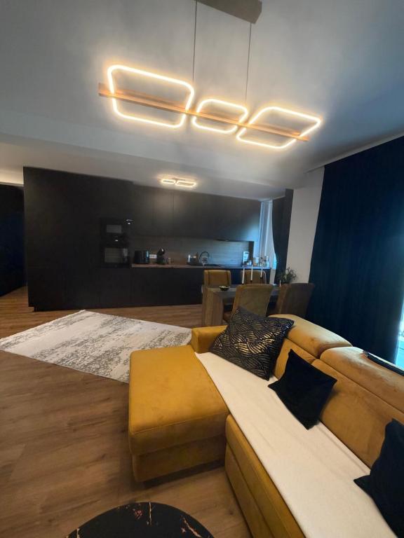 a living room with a couch and a bed at L&D Apartments in Urseni