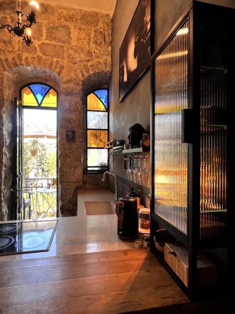 a room with a room with a fireplace and a window at Narkis - A Boutique Stay in the Heart of Jerusalem in Jerusalem