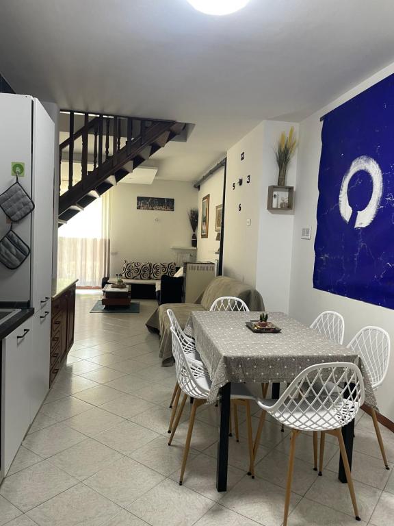 a kitchen and a living room with a table and chairs at Casa Maya Langhe e Roero in Pocapaglia