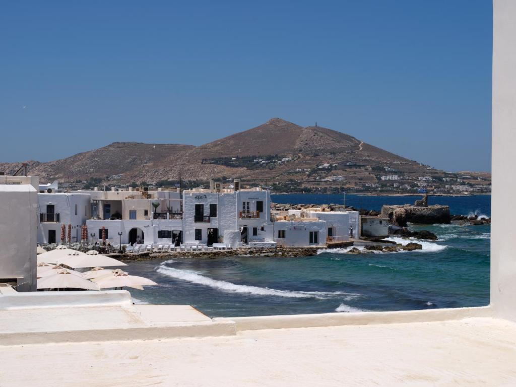 a group of white buildings on the beach at Eugene Sea Side Suite in Naousa