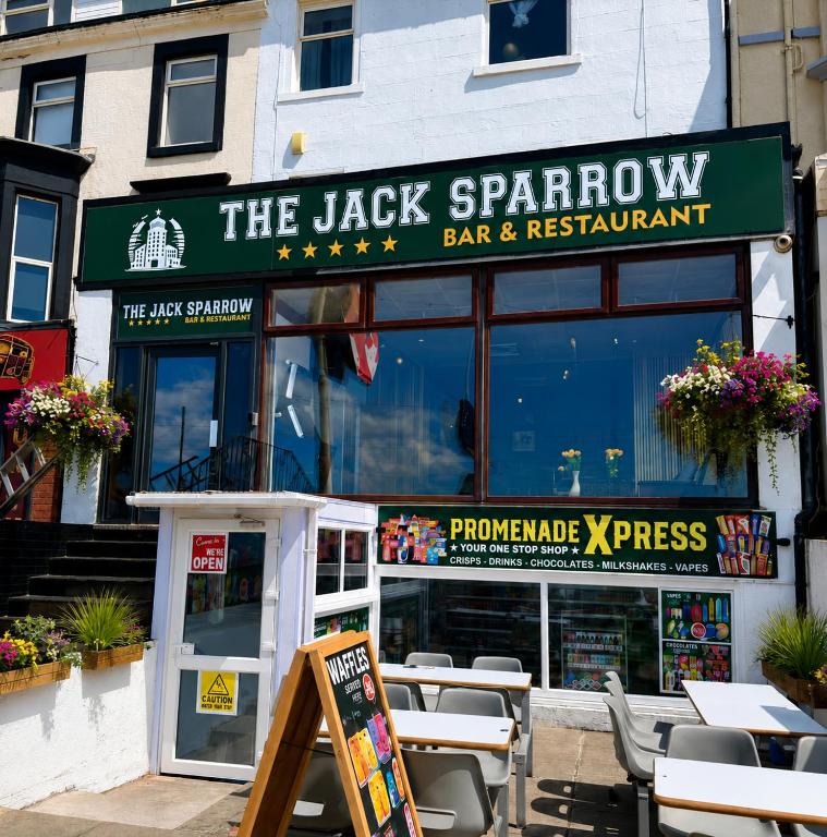 a restaurant with tables and chairs in front of it at The Jack Sparrow Hotel in Blackpool