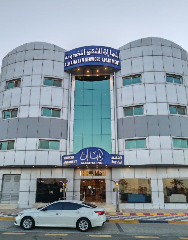 a car parked in front of a building at المها إن للشقق المخدومة in Hail