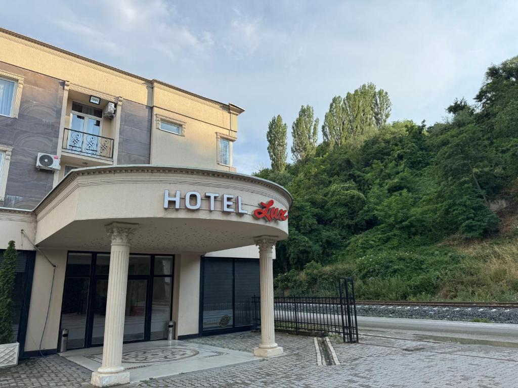 a hotel sign in front of a building at Hotel Lux in Mitrovica