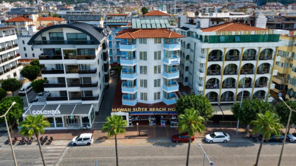 an aerial view of a city with buildings and palm trees at Hawaii Suite Beach Hotel in Alanya