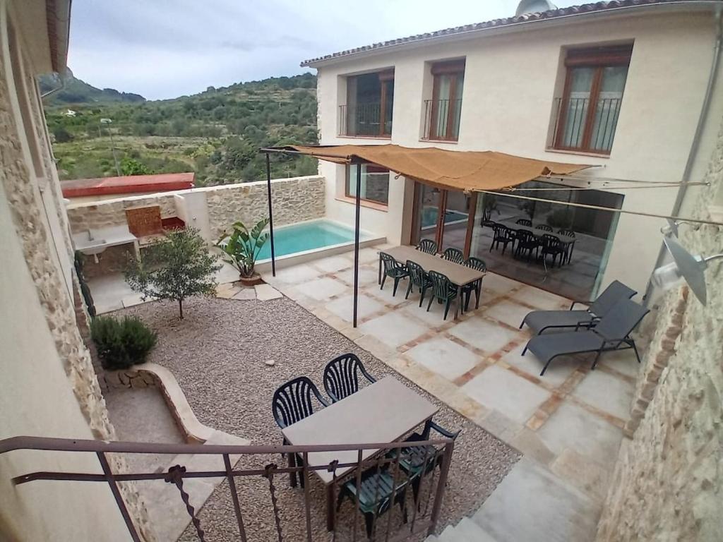 an external view of a house with a patio and a pool at casa LHort in Benisili