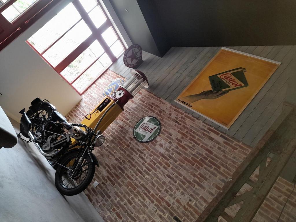 an overhead view of a motorcycle parked in a room at loft with a garage feel in Périers