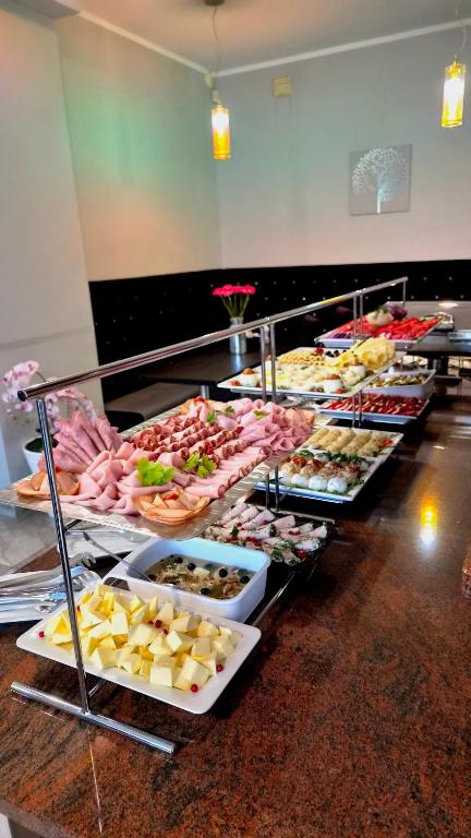 a buffet line with many different types of food at Solar Bed & Breakfast in Karwia