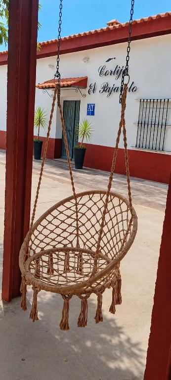 a rattan swing in front of a building at Cortijo El Pajaroto in Matanegra
