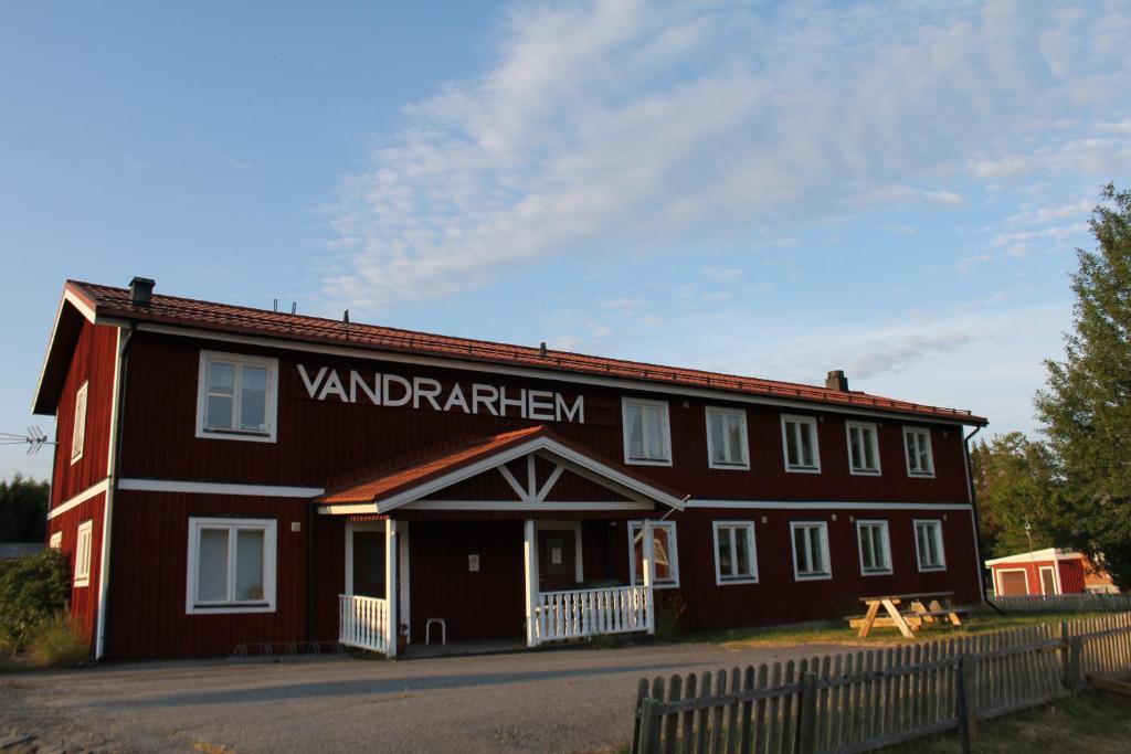a red building with a sign that reads vanderbilt at Norrfällsvikens Vandrarhem in Mjällom