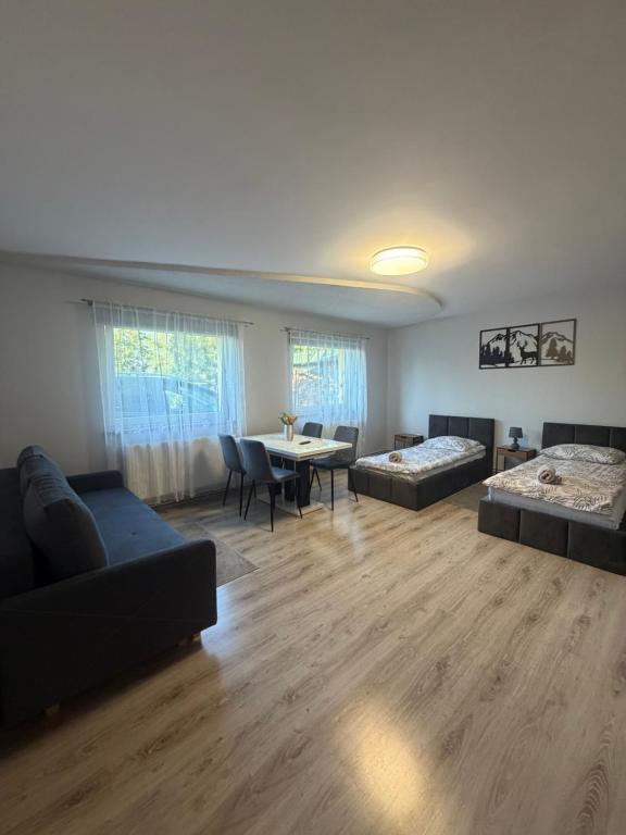 a living room with a couch and a table at W zieleni in Polanica-Zdrój