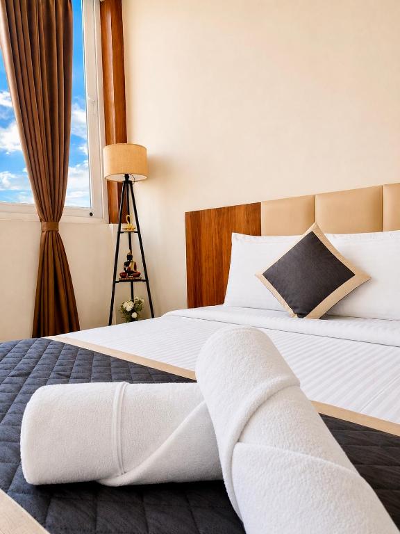 a bedroom with two beds and a window at SS Luxury Comforts - Twin Sharing in Chikmagalūr