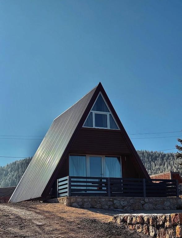a large wooden house with a gambrel roof at Vila Vrela in Žabljak